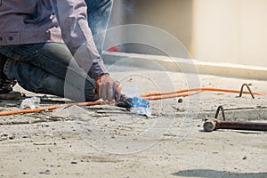 Welder man welding steel bars the supporting the precast concrete wall, worker with unprotected and unsafe.