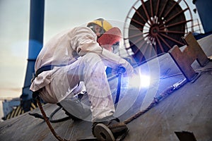 A welder at a shipyard