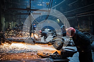 Welder used grinding stone on steel in factory with sparks