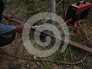 The welder using electrode welding the steel frame with welding machine, Welding sparks light and smoke