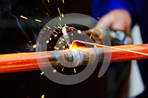 Welder using torch on metal