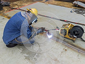 The welder is welding add joint a steel plate with process Flux Cored Arc Welding & x28;FCAW& x29;