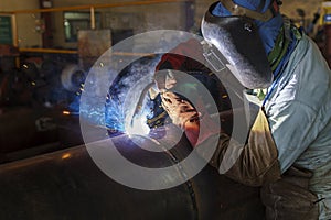 Welder is welding added joint a pipe carbon for steel structure work with process Flux Cored Arc Welding(FCAW)