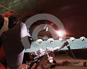 Welder is welding at the big column with MIG Method