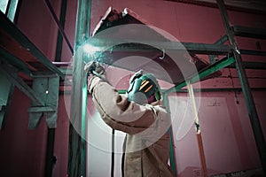 Welder welding in a factory