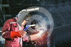 Welder is welding in factory