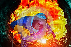 Welder is welding in factory concept