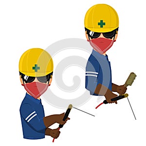 Welder with welding goggles is holding electrode holder and wire brush