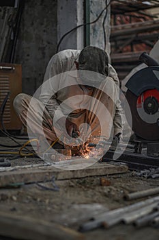 Welder welding metal in his Workshop