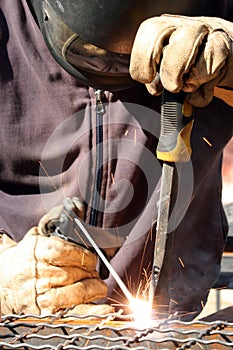 Welder welding a metal part