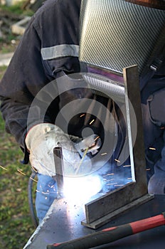 Welder welding a metal part