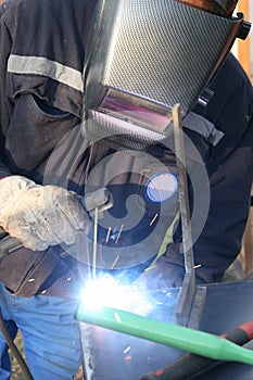 Welder welding a metal part