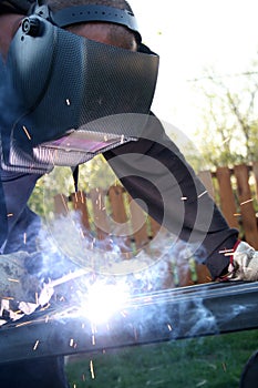 Welder welding a metal part