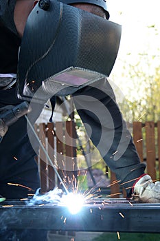 Welder welding a metal part