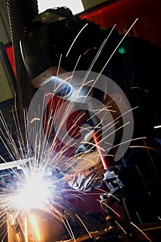 Welder welding a metal part