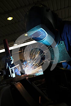 Welder welding a metal part