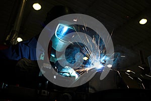 Welder welding a metal part