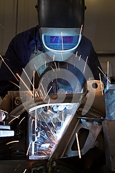 Welder welding a metal part