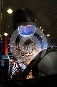 Welder welding a metal part