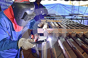 The welder is welding the plate to the pipe with Tungsten Inert Gas Welding process & x28;TIG