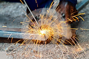 Welder and welding sparks, construction and metal work industrial concept, metal welding with sparks, laborer or labor day concept