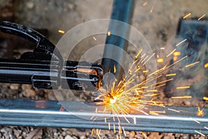 Welder and welding sparks, construction and metal work industrial concept, metal welding with sparks, laborer or labor day concept