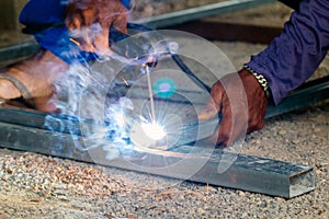 Welder and welding sparks, construction and metal work industrial concept, metal welding with sparks, laborer or labor day concept