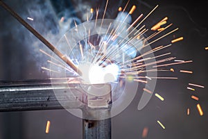 welder and welding sparks, construction and metal work industrial concept, metal welding with sparks, laborer or labor day concept