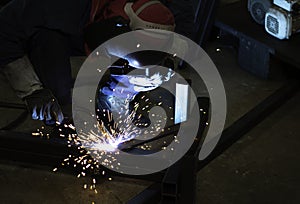 Welder is welding the steel in the factory