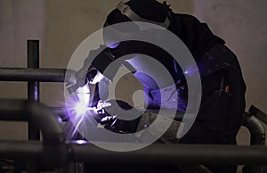 Welder is welding the steel in the factory