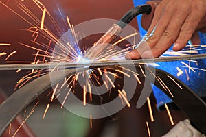 Welder is welding steel flat bar without safety glove