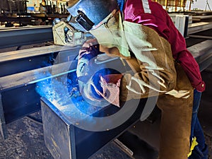 Welder Welding Steel Plate for Steel Structure Work with Process Flux Cored Arc Welding (FCAW)