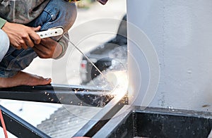 The welder is welding the steel structure to add to the house.