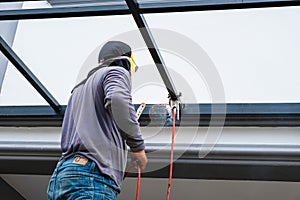 The welder is welding the steel structure to add to the house.