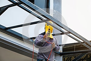 The welder is welding the steel structure to add to the house.