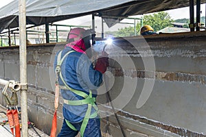 The welder is welding a steel structure work with process Flux Cored Arc Welding& x28;FCAW& x29;