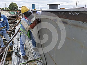 The welder is welding a steel structure work with process Flux Cored Arc Welding& x28;FCAW& x29;