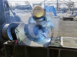 The welder is welding a steel structure work with process Flux Cored Arc Welding& x28;FCAW& x29;