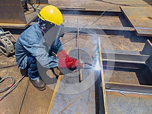 The welder is welding a steel structure work with process Flux Cored Arc Welding& x28;FCAW& x29;