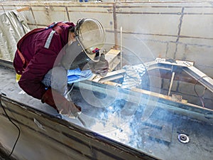 The welder is welding a steel structure work with process Flux Cored Arc WeldingFCAW