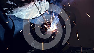 Welder welds a steel pipe