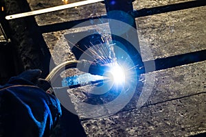 Welder at work in an electromechanical workshop photo