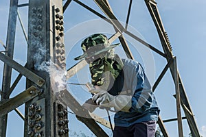 Welder work at high Electric high voltage pole 230 Kv.