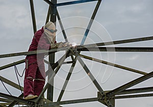 Welder work at high Electric high voltage pole 230 Kv