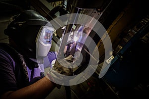 Welder at work in industrial environment