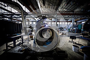 Welder at work in industrial environment