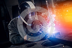 Welder work with metal parts car in factory, sparks and electricity