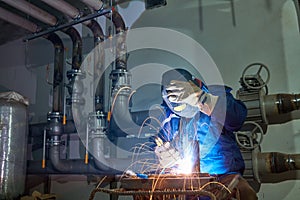 Welder worker at industrial arc welding work