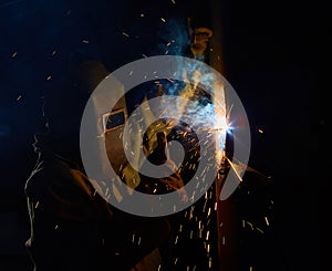 Welder worker welding metal by electrode