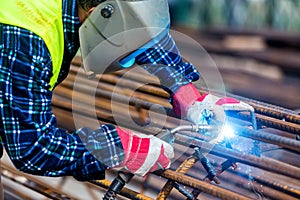 Welder worker welding metal by electrode